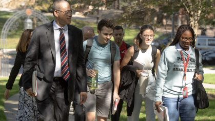 President Jonathan Holloway walking with students
