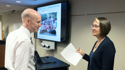 Senior Director of Brand and Marketing Rebecca Boucher (r.) chats with participants of the Communicators Certificate Program workshop/class "Understanding the Rutgers Identity"