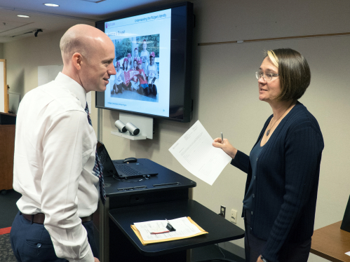 Senior Director of Brand and Marketing Rebecca Boucher (r.) chats with participants of the Communicators Certificate Program workshop/class "Understanding the Rutgers Identity"